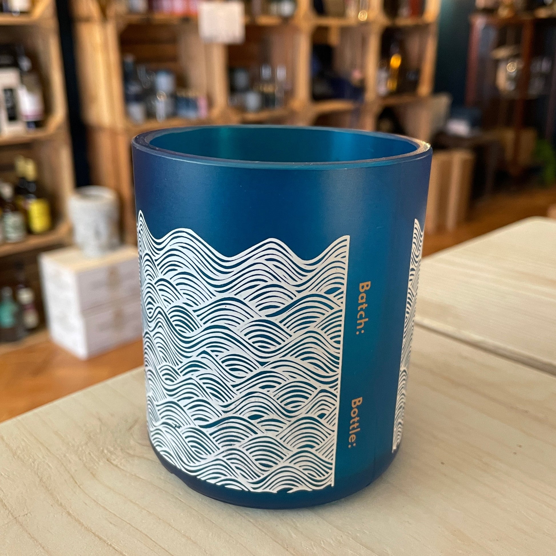 An upcycled Barry Island Gin Glass on a table